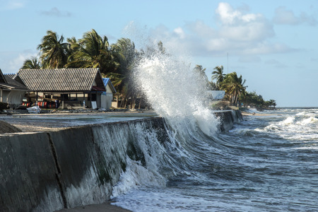 NAKORN SRI THAMMARAT THAILAND - January 11 : Raging waves to shore, and the houses of the fishermen. on Jan. 11, 2015 in Nakorn sri thammarat, Thailand.のeditorial素材