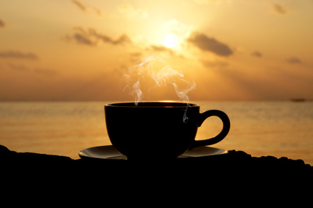 Silhouettes of morning coffee on the lake.の写真素材