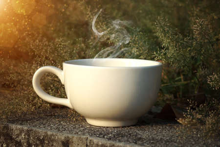 Coffee cup with small flower grass