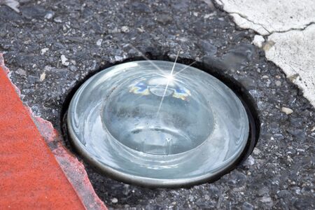 Round glass reflector on the road To prevent damageの写真素材