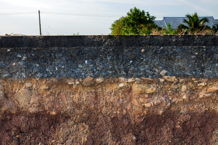 The curb erosion from storms. To indicate the layers of soil and rock.の写真素材