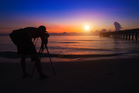Silhouette of photographer on the beach.の写真素材