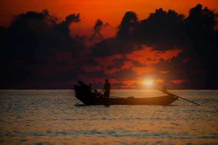 Beautiful sky and Silhouettes of Minimal fisherman at the sea.の写真素材