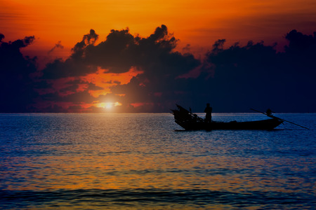 Beautiful sky and Silhouettes of Minimal fisherman at the sea.の写真素材
