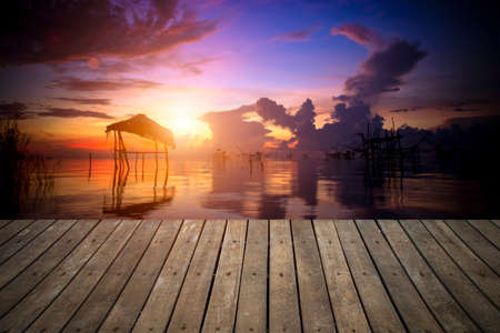 Wooden walkway on the lake in the morning with the sunrise.の写真素材