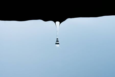 rain drops from shelter in rainy seasonの写真素材