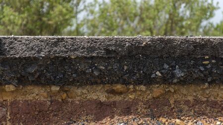 The curb erosion from storms. To indicate the layers of soil and rock.の写真素材