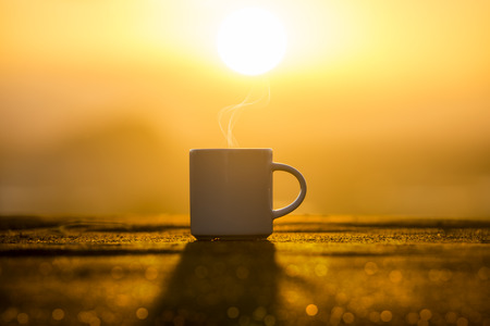 White Coffee cup in the morning time with sunrise.の写真素材