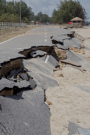 Road erosion caused by waves and severe storms.の写真素材