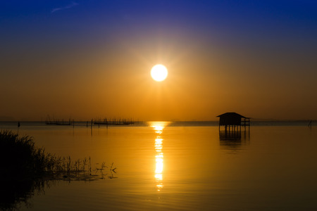 Sunset sky on the lake in south of Thailand., un-focus image.の写真素材
