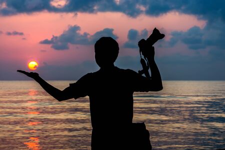 Silhouettes of photographers with the sunrise.の写真素材
