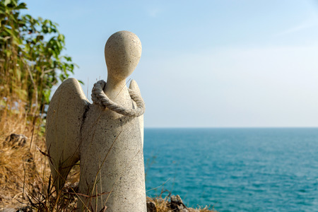 Guardian angel statue on the cliffs of the island, Thailand.の写真素材