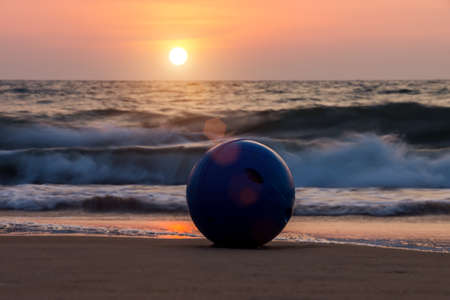 Sunset at the andaman sea with blue ball on the beach, Thailandの写真素材