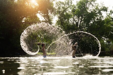 SONGKHLA THAILAND - July 12, 2015: Lifestyle Children were playing water in the lake on July 12, 2015 in Songkhla, Thailand.のeditorial素材