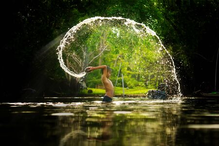 SONGKHLA THAILAND - July 12, 2015: Lifestyle Children were playing water in the lake on July 12, 2015 in Songkhla, Thailand.のeditorial素材