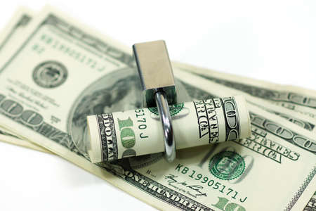 dollar currency notes with lock and chain.