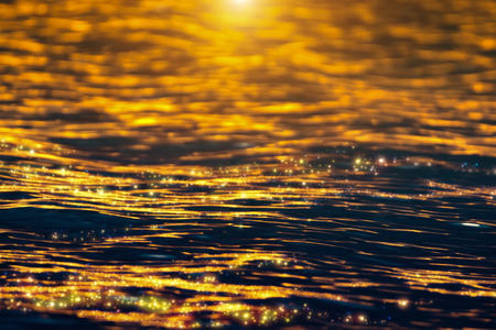 The water surface at the lake with sparkles light of sunset.の写真素材