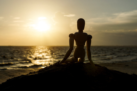 Silhouettes of wooden models feel lonely at sunset.の写真素材