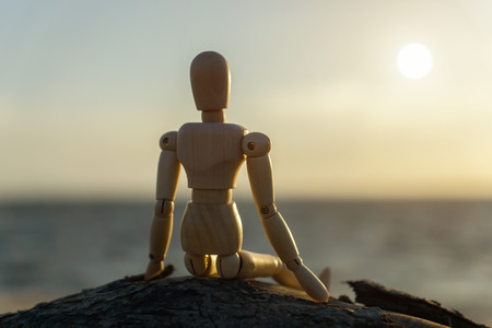 Silhouettes of wooden models feel lonely at sunset.の写真素材