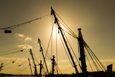 The silhouette masts of fishing boats with sunlight.の写真素材