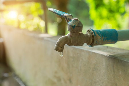 Defective faucet. Cause wastage of water with sunlight.の写真素材