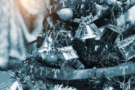 Decorated Christmas tree on blurred background in winter color tone.の写真素材