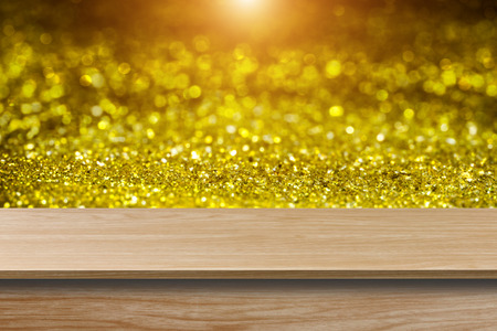 Wood floor with gold glitter bokeh background and light.の写真素材