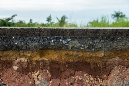 The layer of asphalt road with soil and rock. Un-focus image.の写真素材