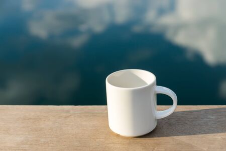 White coffee mug in the morning time.