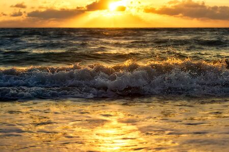 Motion and glow wave on the beach with morning sunrise sky.