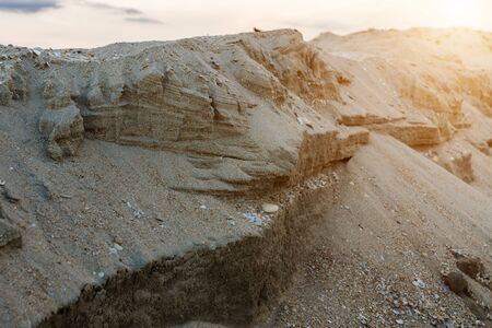Layer of sand and shell at the beach with sunlight.