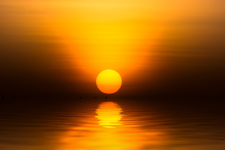 Big sunrise in golden hour at the lake.の写真素材
