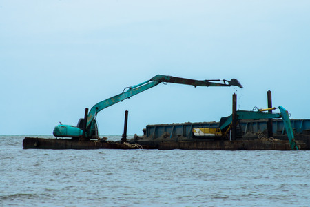 Machines are dredging sand in the sea. For use in industry.の写真素材