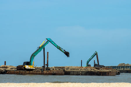 Machines are dredging sand in the sea. For use in industry.の写真素材