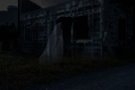 Low key image a blur white ghost at Abandoned house. Concept: Halloween Festivalの写真素材