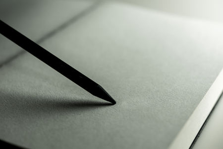 Close up A Blank page of book and black pencil with Shadow on a paper.の写真素材