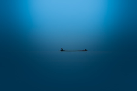 Minimal of the fishing boat on the lake.の写真素材