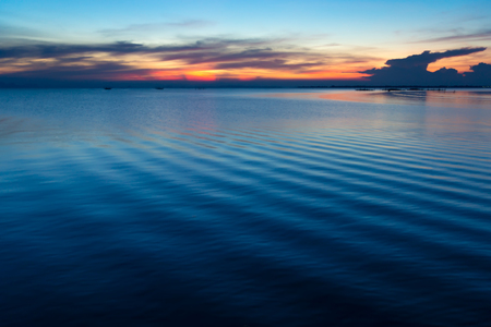 Twilight sky at the lake with water wave.の写真素材