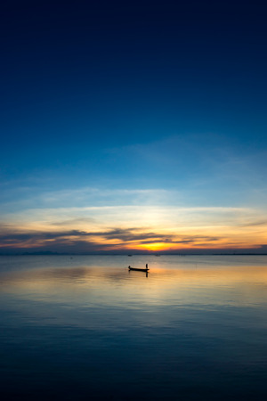 Minimal the fishing boat on the lake.の写真素材