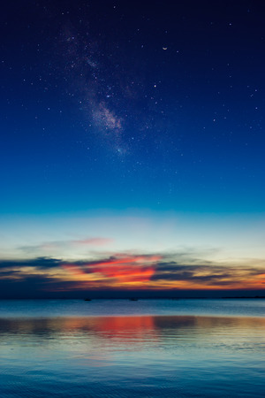 Twilight sky at the lake with crescent moon and star.の写真素材