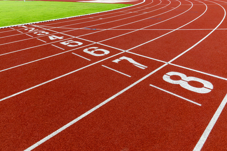 Red treadmill at the stadium with the white numbering from one to eightの写真素材