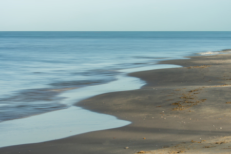 Nobody on the beach with motion wave and space in summer season.の写真素材