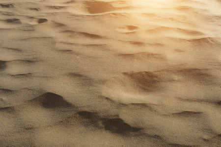 Sand background texture with sunlight