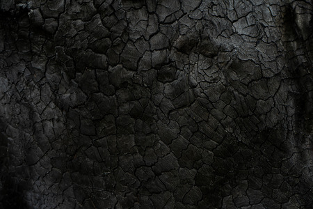 Low key image the Surface of charcoal background. This image is not in focus.