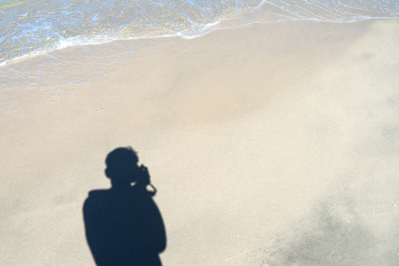 Men's shadow on the sand with space.の写真素材