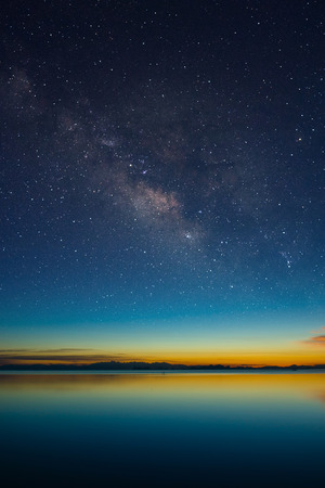 The sky with stardust at the lake in the twilight after sunset.の写真素材