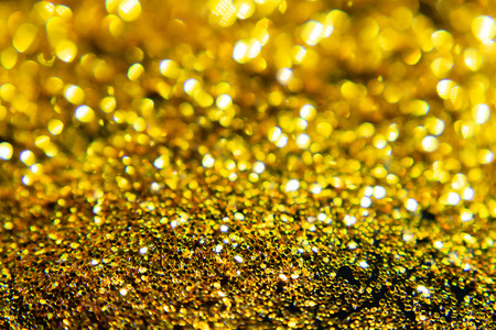 Golden Sparkling glitter bokeh background with light.の写真素材