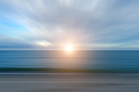 Abstract minimal of sunrise with motion clouds and line of sea on the beach.の写真素材