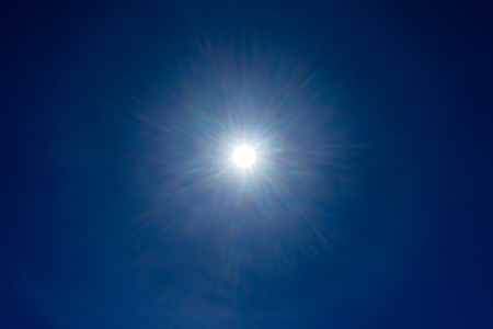 Sun rays on blue sky.の写真素材