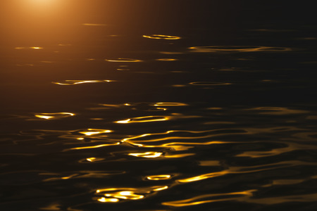 Defocus Water surface images reflect the sunlight at the lake in golden timeの写真素材